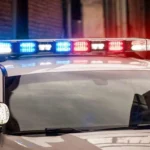 Police investigate a fatal crash scene near a stop sign and tractor-trailer in Foster, Rhode Island