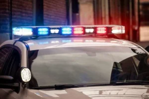 Police investigate a fatal crash scene near a stop sign and tractor-trailer in Foster, Rhode Island