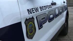 Police tape near a New Bedford intersection after a motorcycle and sedan crash
