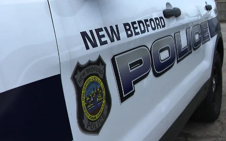Police tape near a New Bedford intersection after a motorcycle and sedan crash